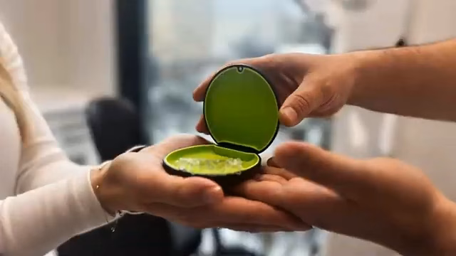 Close-up prop interaction shot with shallow depth of field, highlighting a symbolic handoff using focused staging.